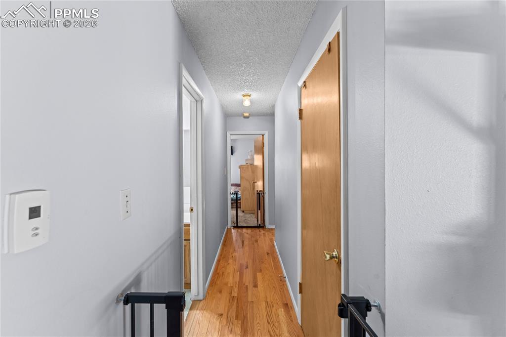 Image 14 of 47: Hallway featuring wood-finish flooring