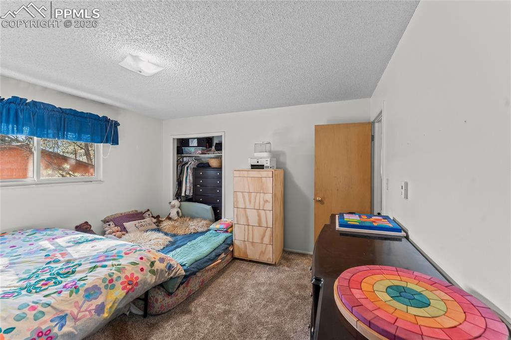 Image 19 of 47: Carpeted room featuring a window, ceiling-mounted light fixture, open close