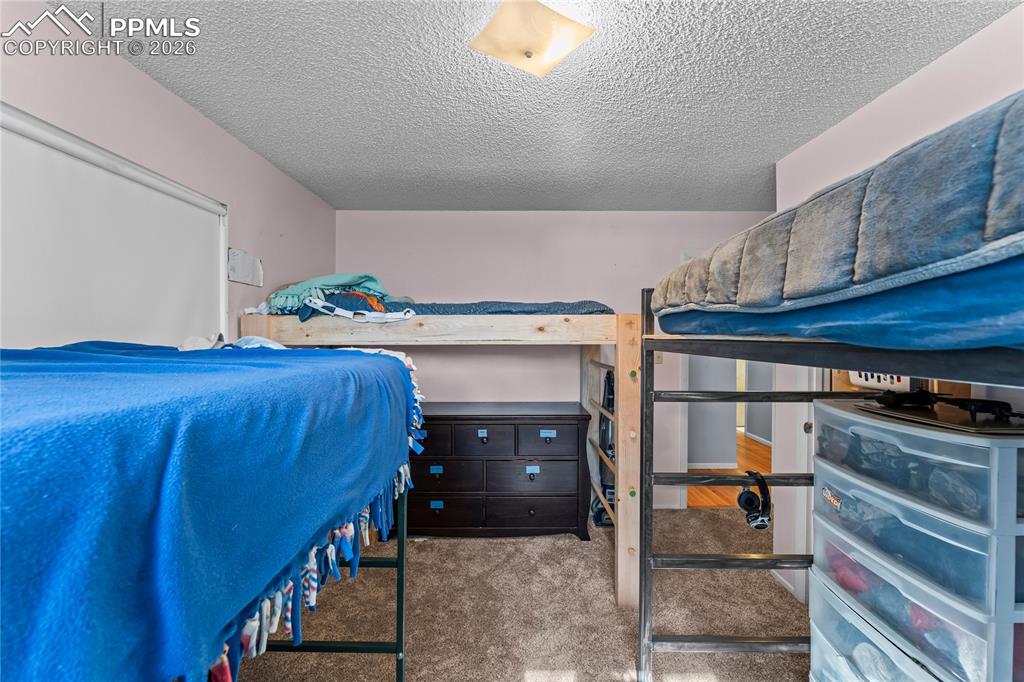 Image 21 of 47: Room featuring textured ceilings and neutral wall paint