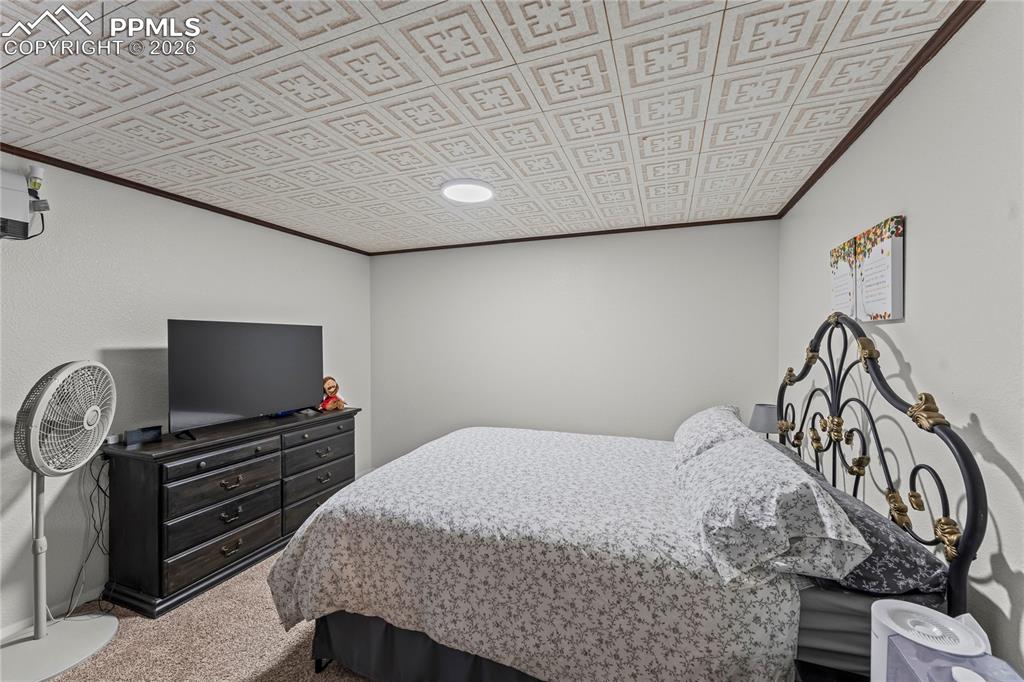 Image 33 of 47: Textured ceiling with a geometric pattern, recessed lighting, and crown mol