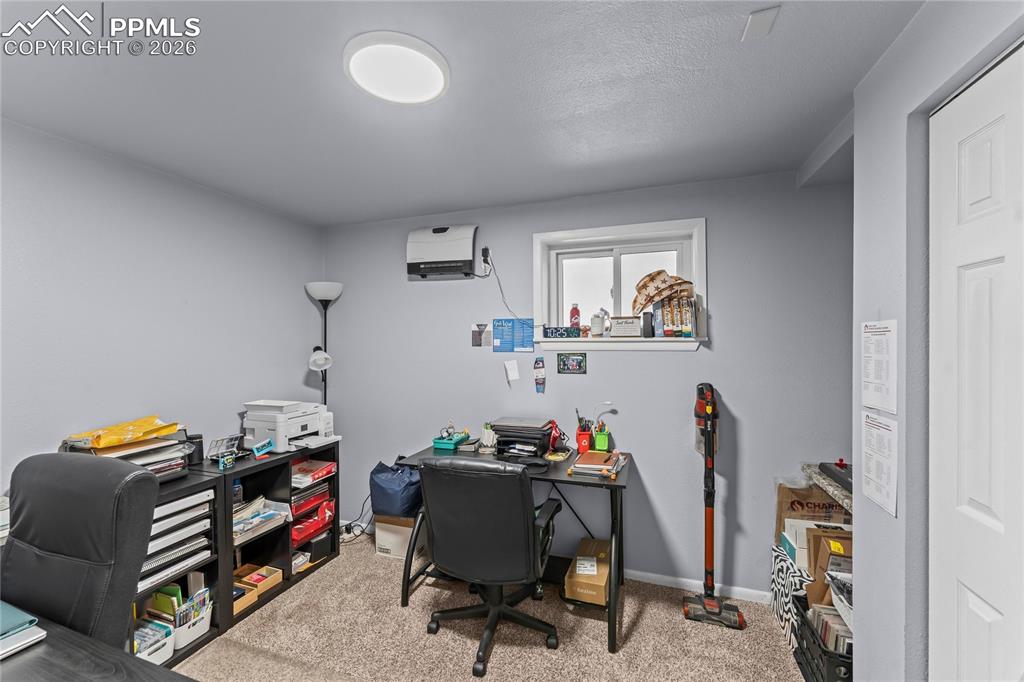 Image 35 of 47: Carpeted room with light gray walls, a window with white trim, and a white 
