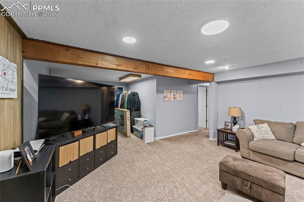Image 38 of 47: Spacious room featuring broadloom carpet, recessed ceiling lighting, and a 