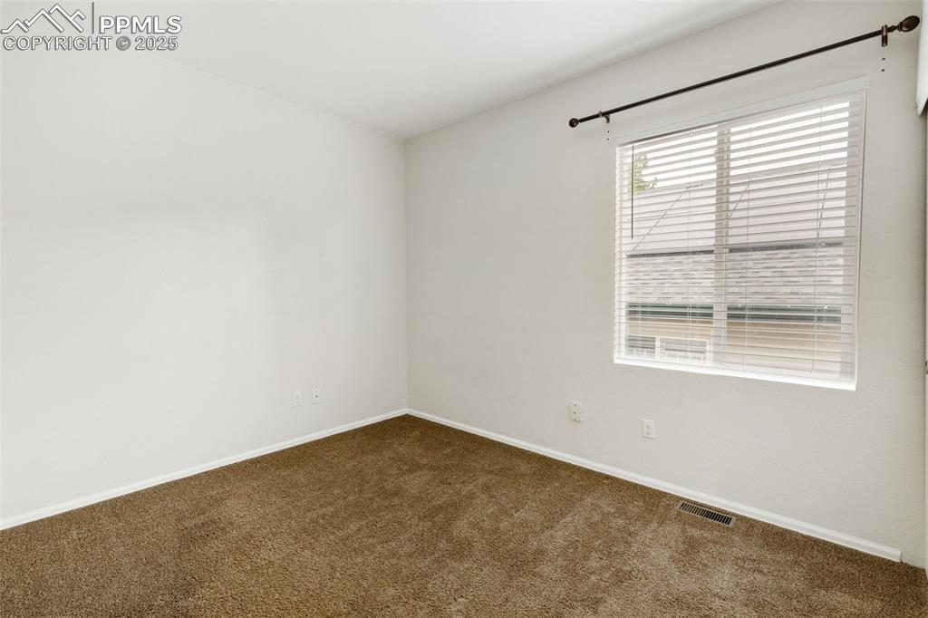 Image 23 of 35: Carpeted spare room with baseboards