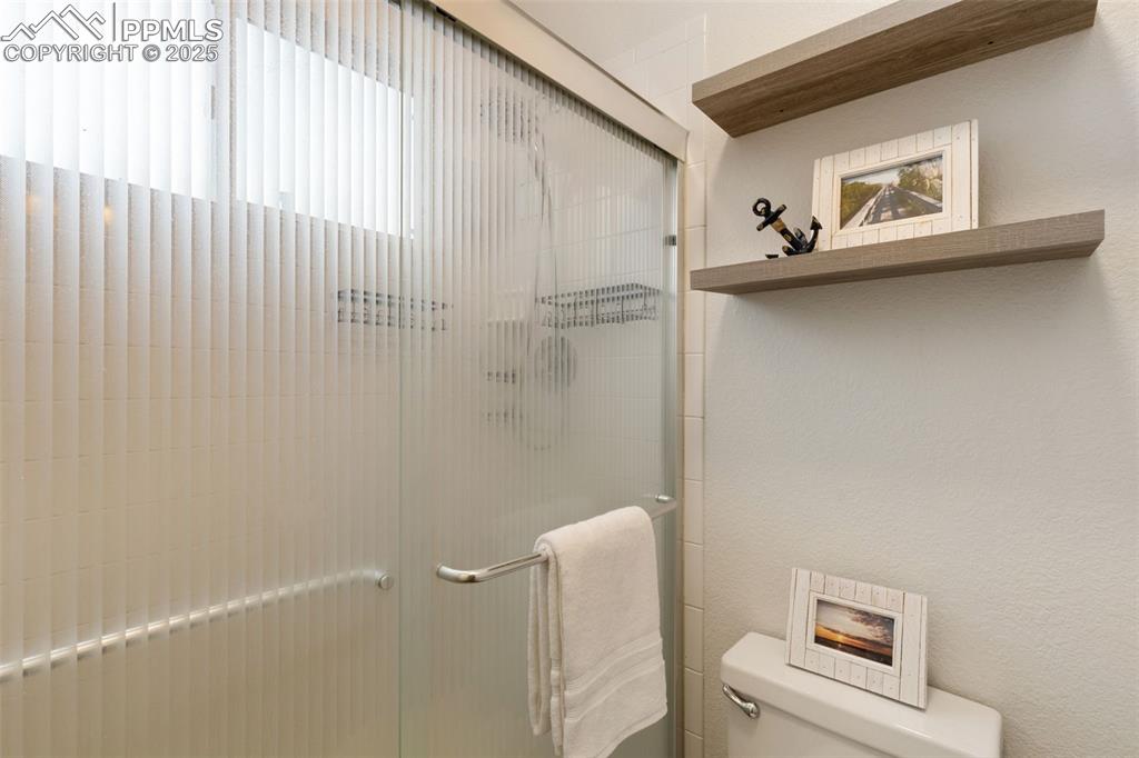 Image 26 of 35: Bathroom with a stall shower