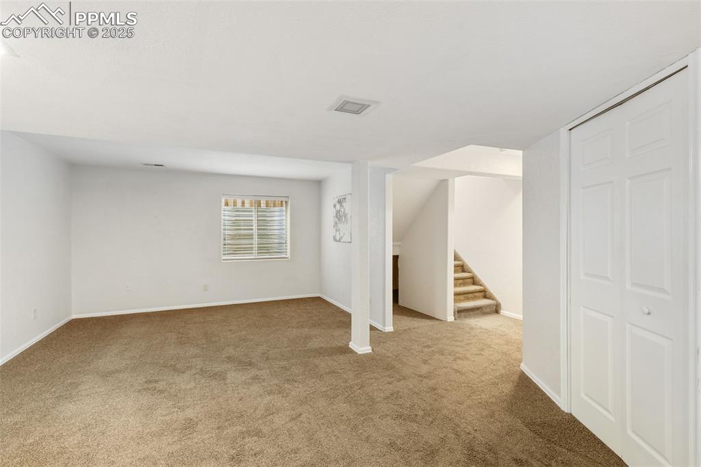Image 31 of 35: Basement featuring carpet flooring and stairs