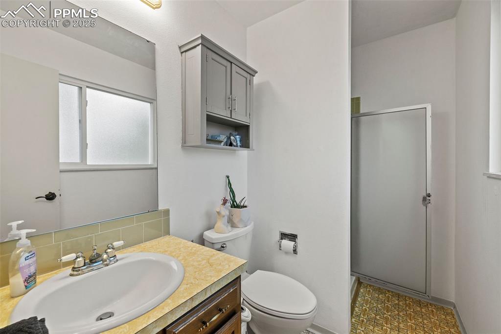 Image 23 of 50: Bathroom featuring vanity and a stall shower