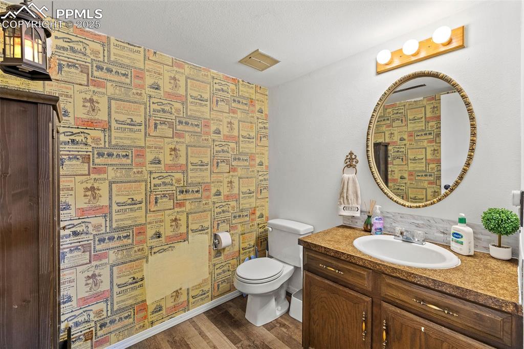 Image 30 of 50: Bathroom featuring vanity and dark wood-type flooring