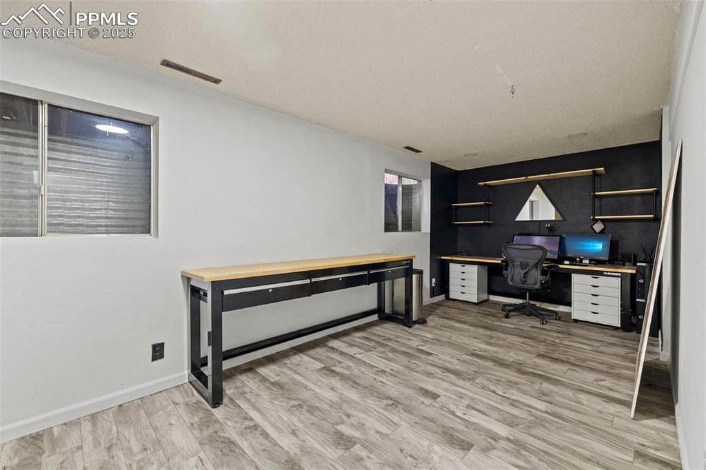 Image 35 of 50: Office area featuring light wood-style floors and baseboards