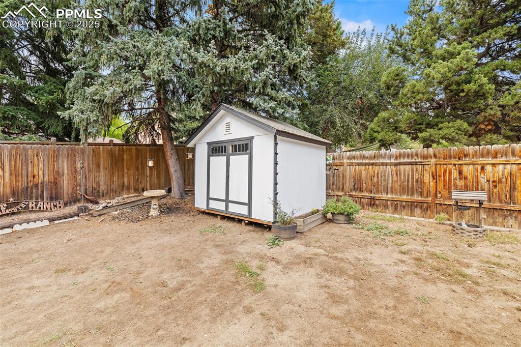 Image 41 of 50: View of shed with a fenced backyard