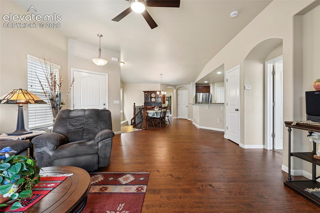 Image 13 of 38: View from Living room to dining area and kitchen