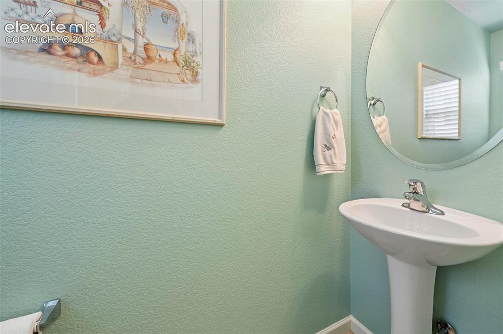 Image 23 of 38: Powder room with Pedestal sink with chrome faucet
