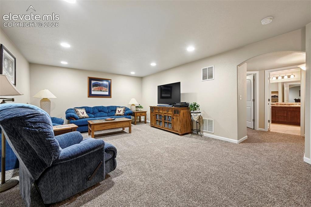 Image 26 of 38: Large Family room with recessed lighting and a neutral wall color
