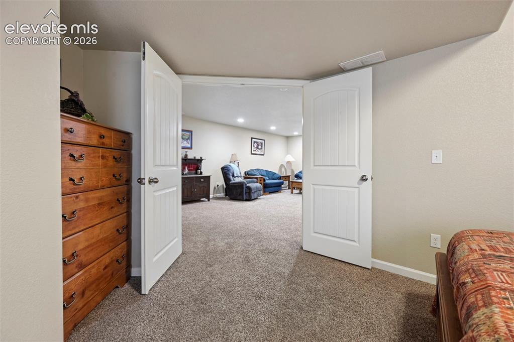 Image 29 of 38: Basement Bedroom 1 with double doors