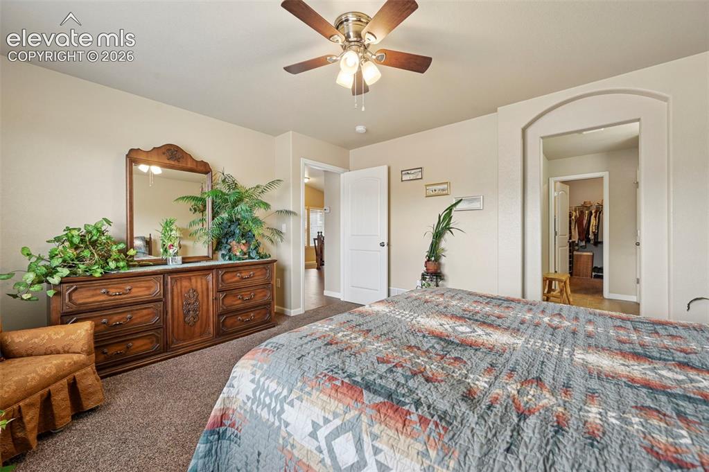 Image 7 of 38: Primary suite with attached bath with walk-in closet