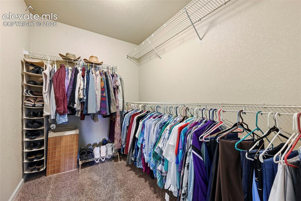 Image 8 of 38: Walk in closet with wire shelving and hanging rods