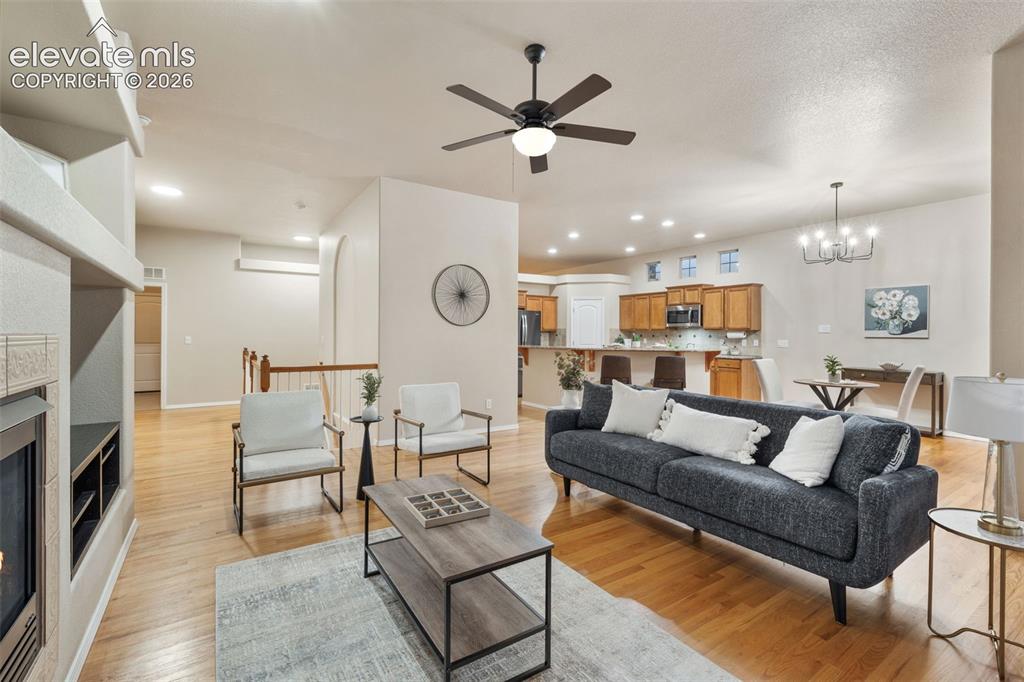 Image 15 of 50: Hardwood-finish flooring, built-in fireplace, vaulted ceiling, recessed lig