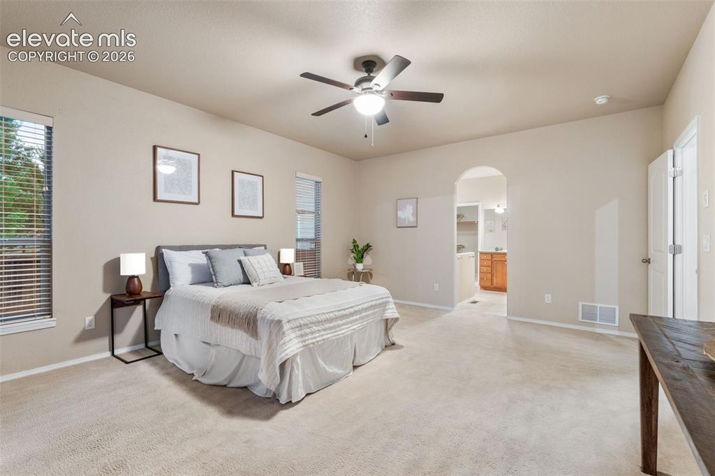 Image 17 of 50: Carpeted room with vaulted ceiling and a ceiling fan