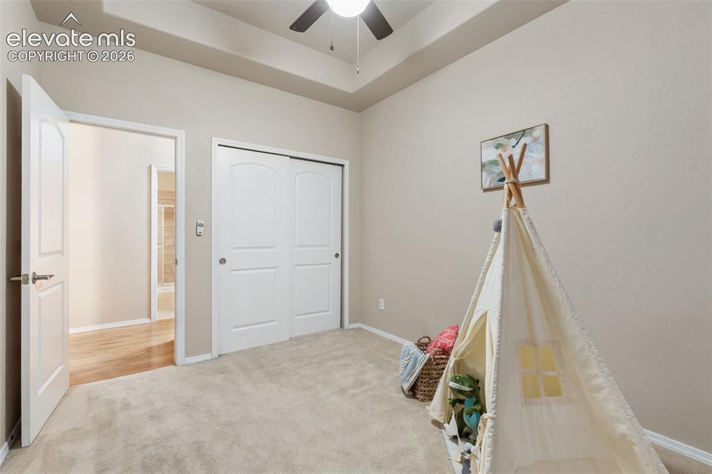 Image 22 of 50: Recessed ceiling, carpeted flooring, white interior doors, and a ceiling fa