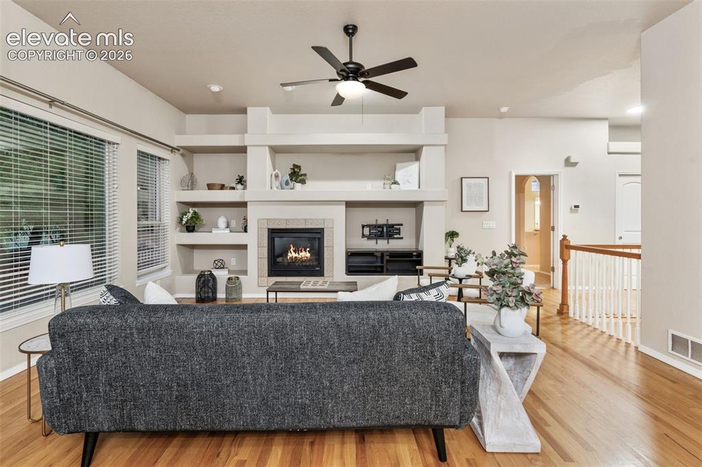 Image 3 of 50: Recessed lighting with a ceiling fan, a fireplace with a tile surround, bui