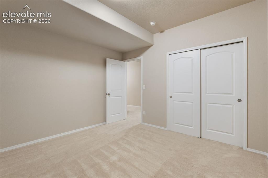 Image 33 of 50: Wall-to-wall carpeting, neutral wall color, white trim, and two-panel inter