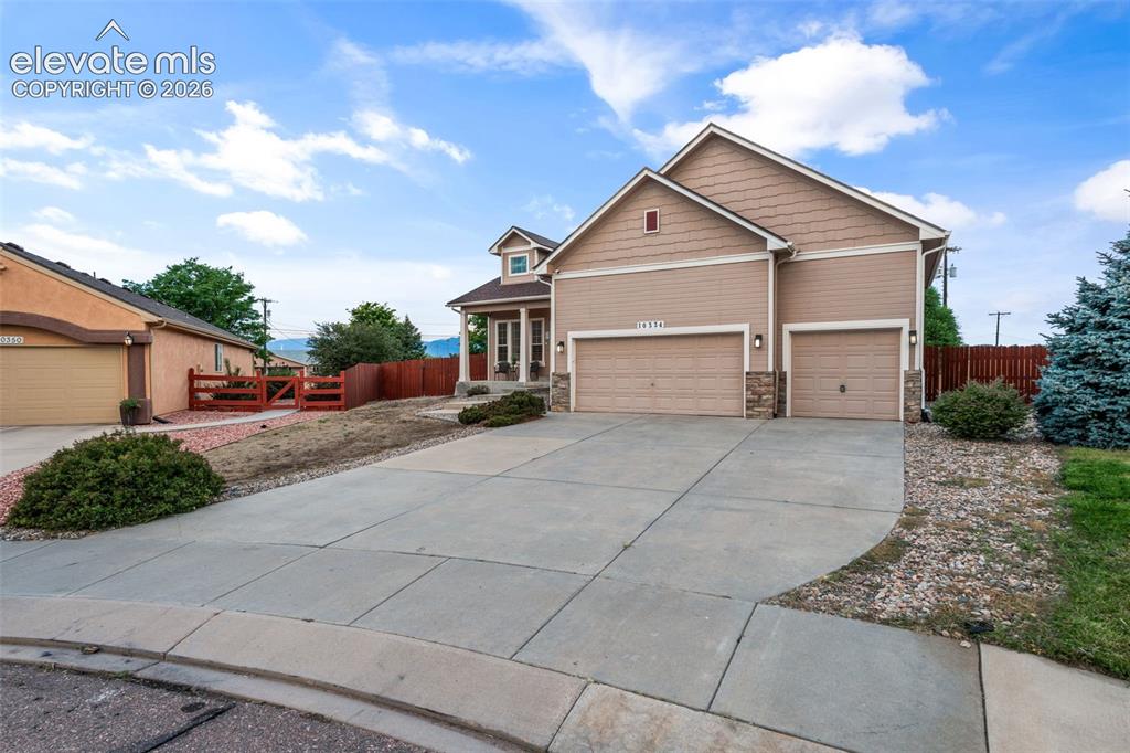 Image 4 of 50: Exterior featuring a two-car garage, an additional single-car garage, a cov