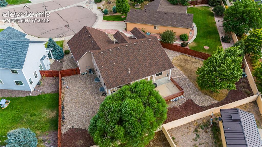 Image 44 of 50: Expansive property featuring a multi-level roofline, wood fencing, and a gr