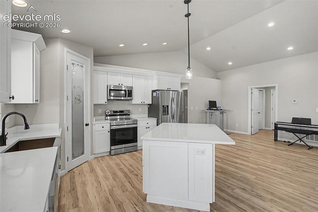 Image 25 of 47: Spacious kitchen featuring white cabinetry, stainless steel appliances, a c