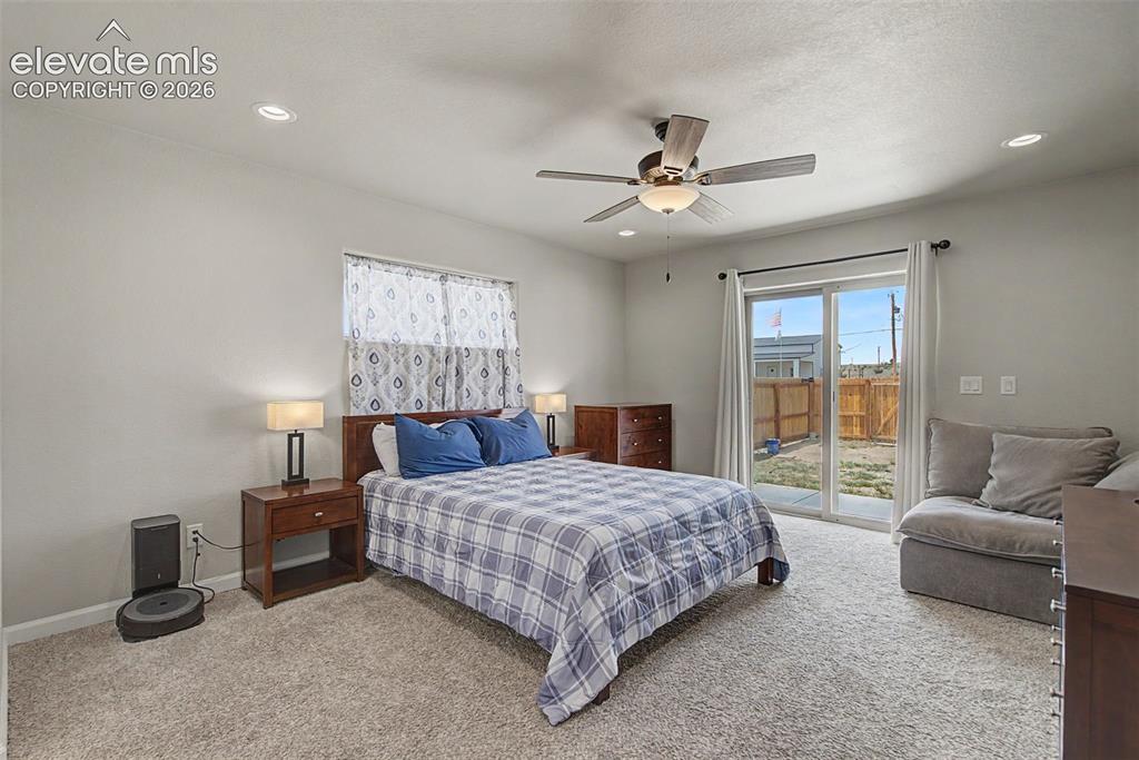 Image 29 of 47: Spacious bedroom featuring light-colored walls, recessed lighting, and a ce