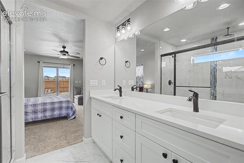 Image 31 of 47: Contemporary bathroom featuring a double vanity with white cabinetry, integ