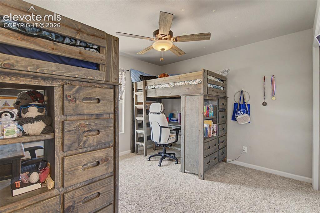 Image 35 of 47: Carpeted room featuring a ceiling fan with integrated lighting, two built-i