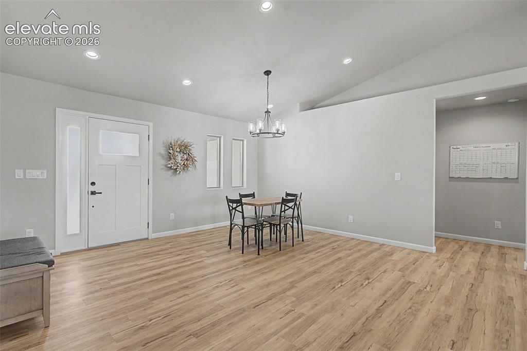 Image 38 of 47: Open concept living space featuring wood-finish flooring, recessed lighting