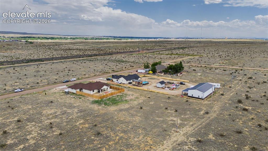 Image 43 of 47: Expansive rural land featuring multiple residential structures and outbuild