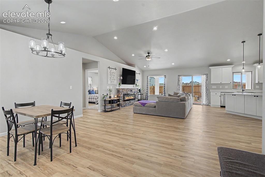 Image 47 of 47: Open-concept living space featuring wood-finish flooring, vaulted ceilings,