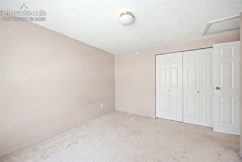 Image 22 of 39: Upper level bedroom. AI removed items from bedroom. This picture may not
