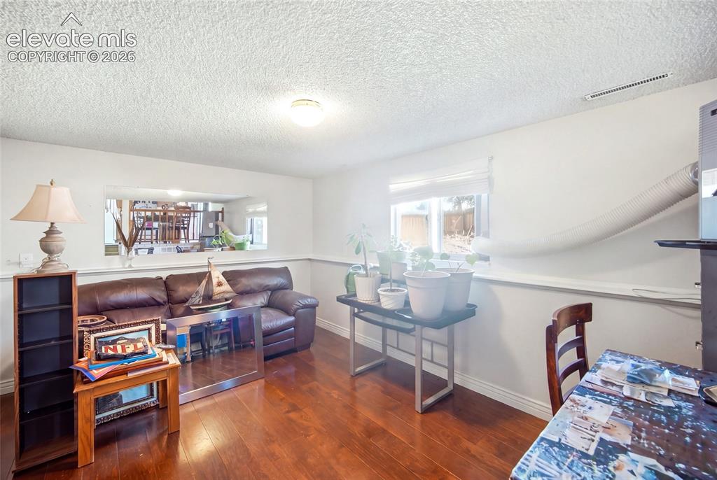 Image 24 of 39: Lower level family room with wood flooring
