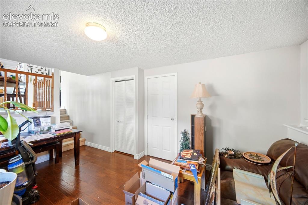 Image 26 of 39: Lower level family room with wood flooring