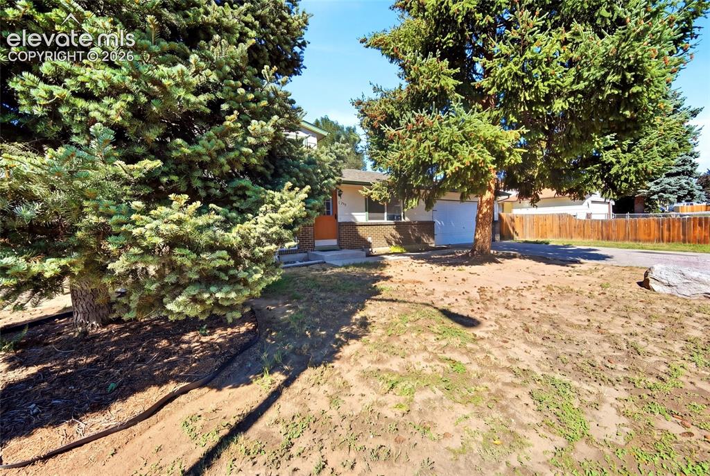 Image 37 of 39: Rear yard, fenced, mature trees