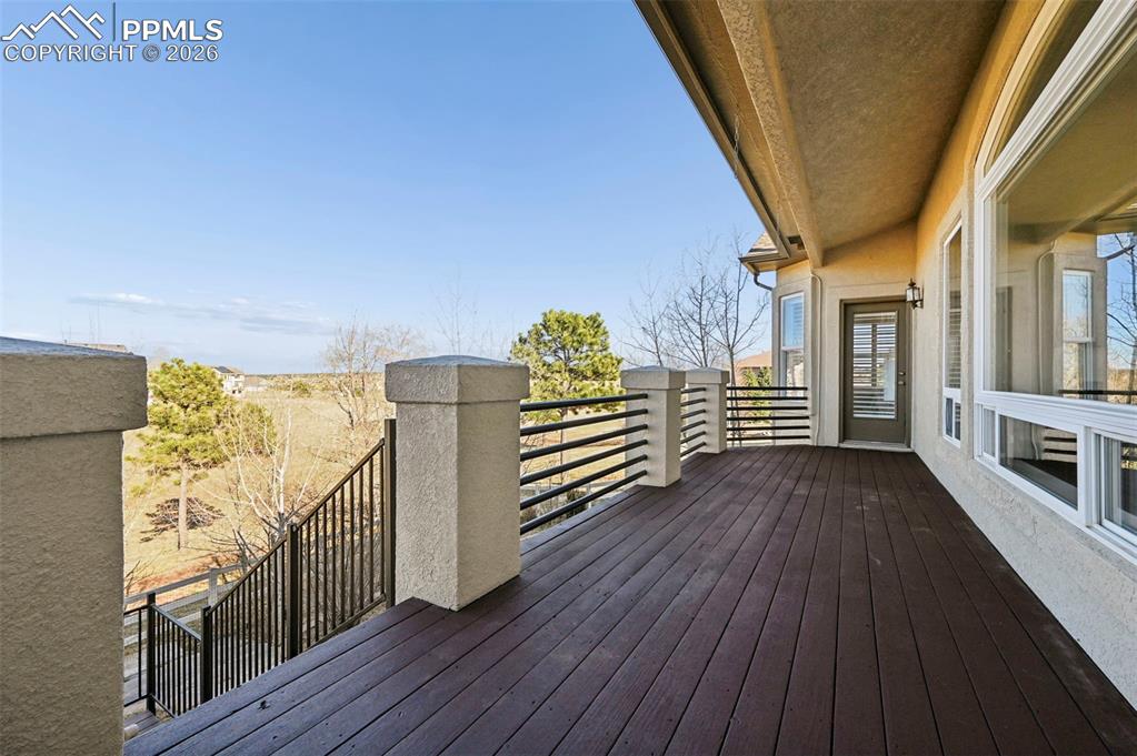 Image 14 of 50: Walk out deck off of kitchen and primary bedroom