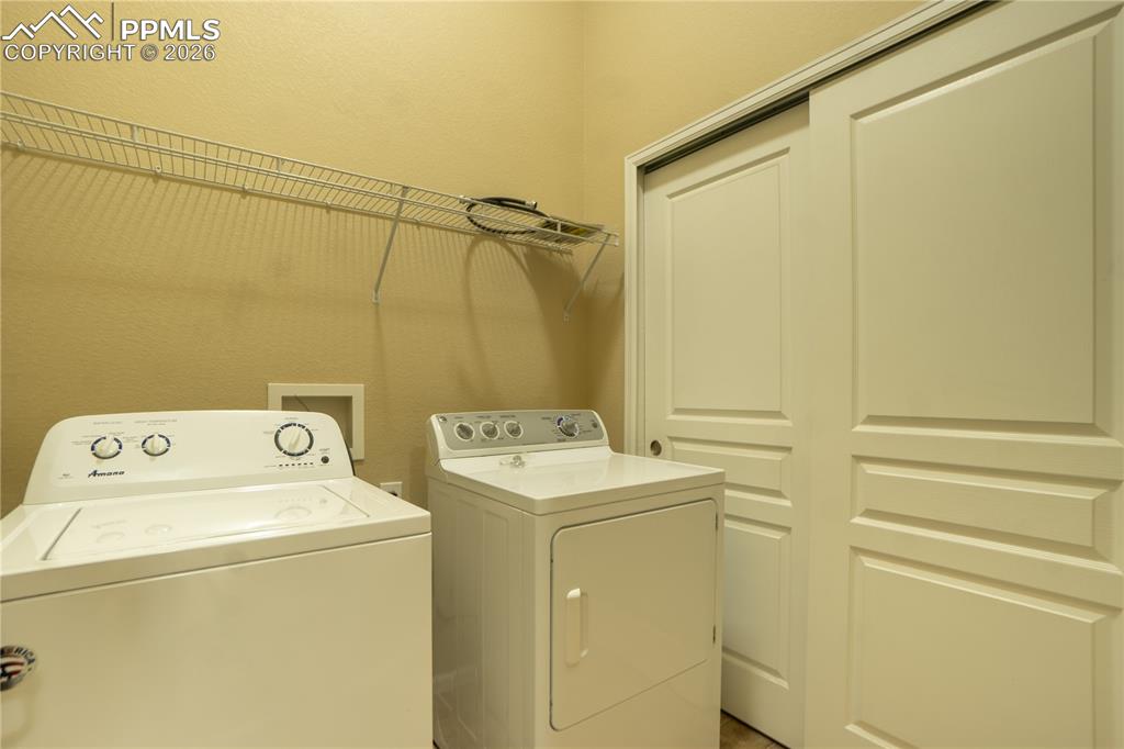 Image 15 of 33: Laundry area with separate washer and dryer