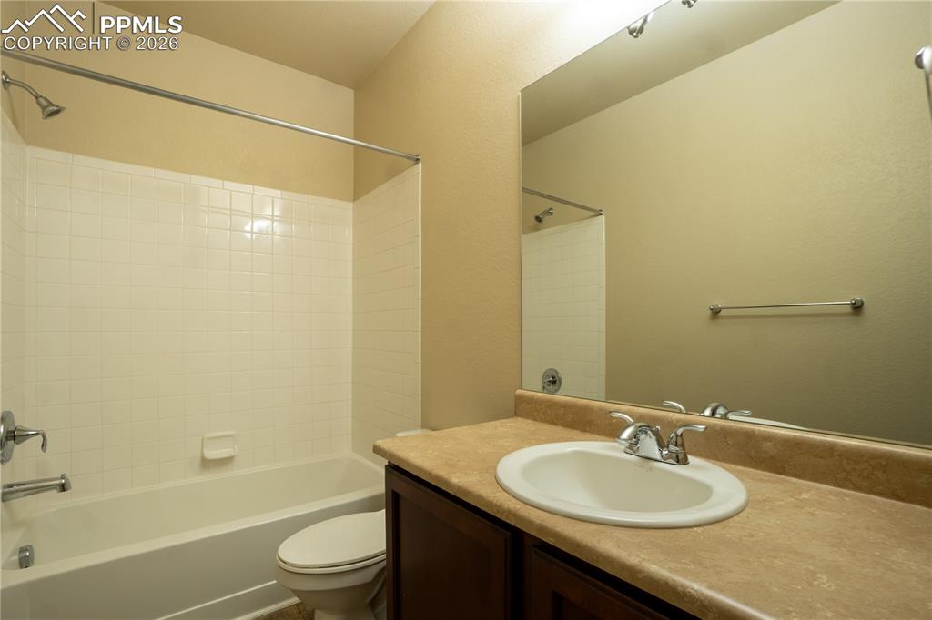 Image 16 of 33: Bathroom with vanity and  shower combination