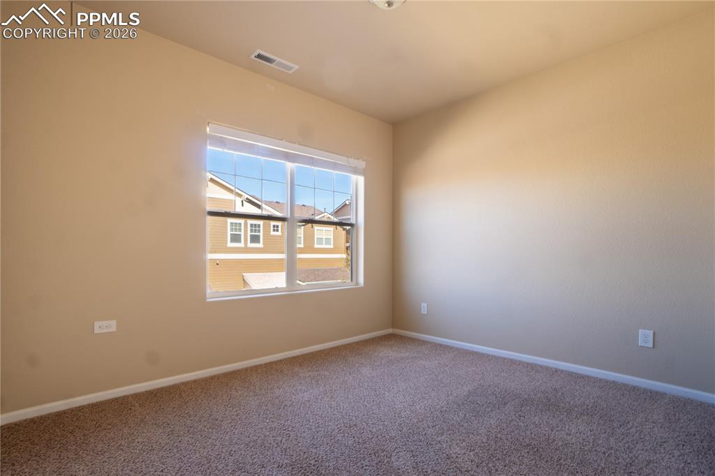 Image 17 of 33: Empty room featuring carpet flooring and baseboards