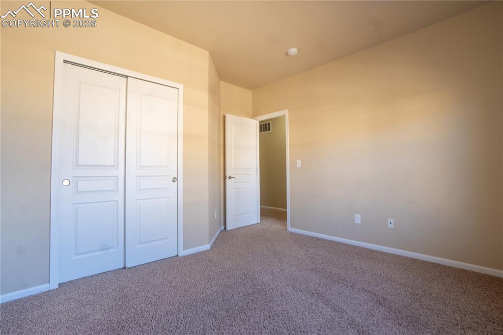 Image 18 of 33: Unfurnished bedroom with carpet floors and a closet