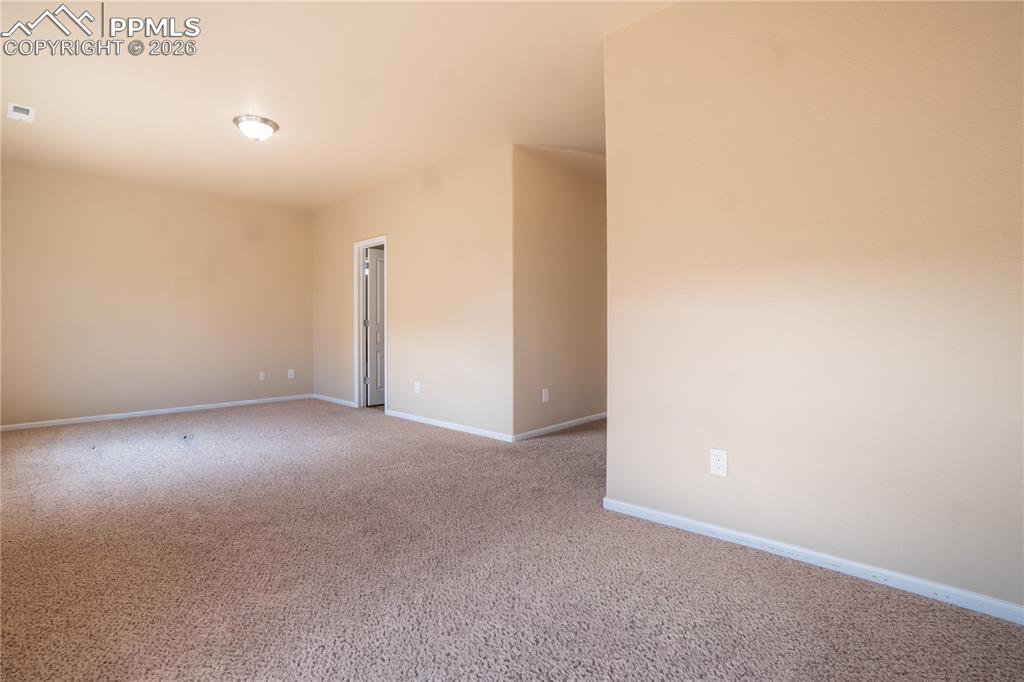 Image 23 of 33: Empty room featuring light carpet and baseboards