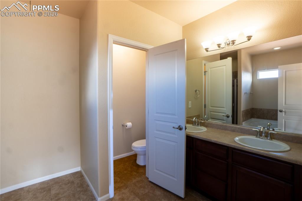 Image 26 of 33: Full bathroom featuring double vanity and a garden tub