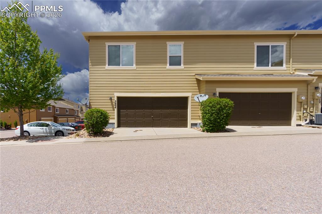 Image 30 of 33: Traditional-style home with a garage and concrete driveway