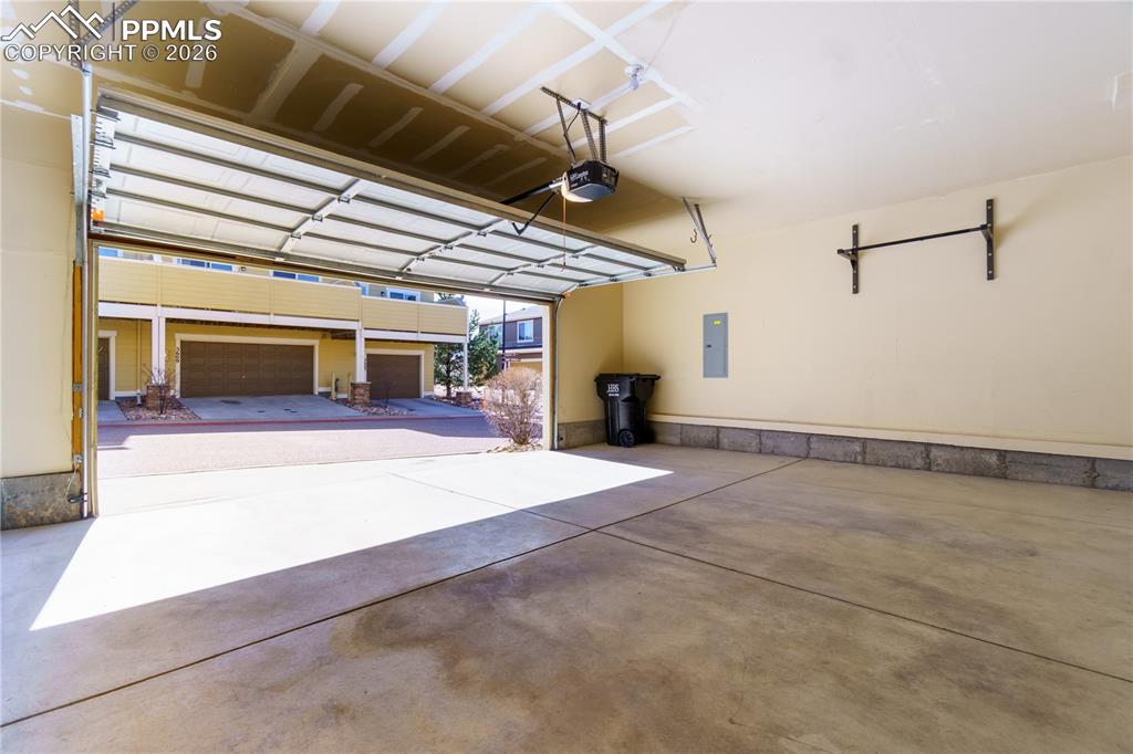 Image 33 of 33: Garage featuring electric panel and a garage door opener