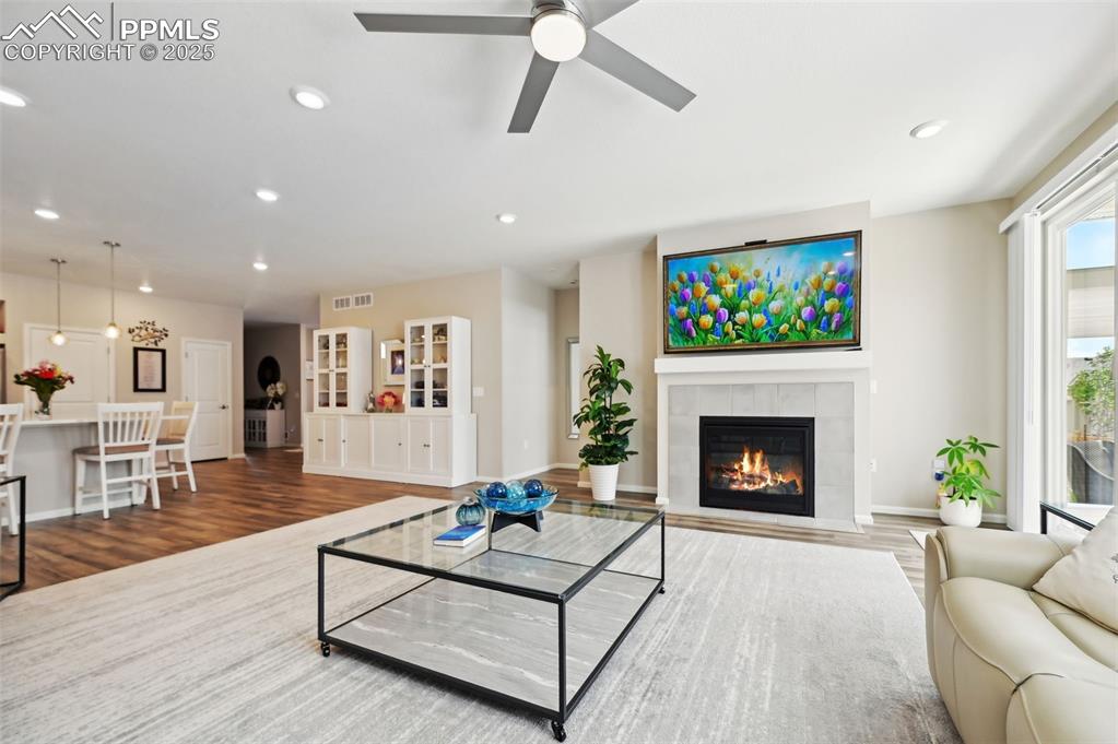 Image 11 of 44: Living area with recessed lighting, wood finished floors, a fireplace, ceil