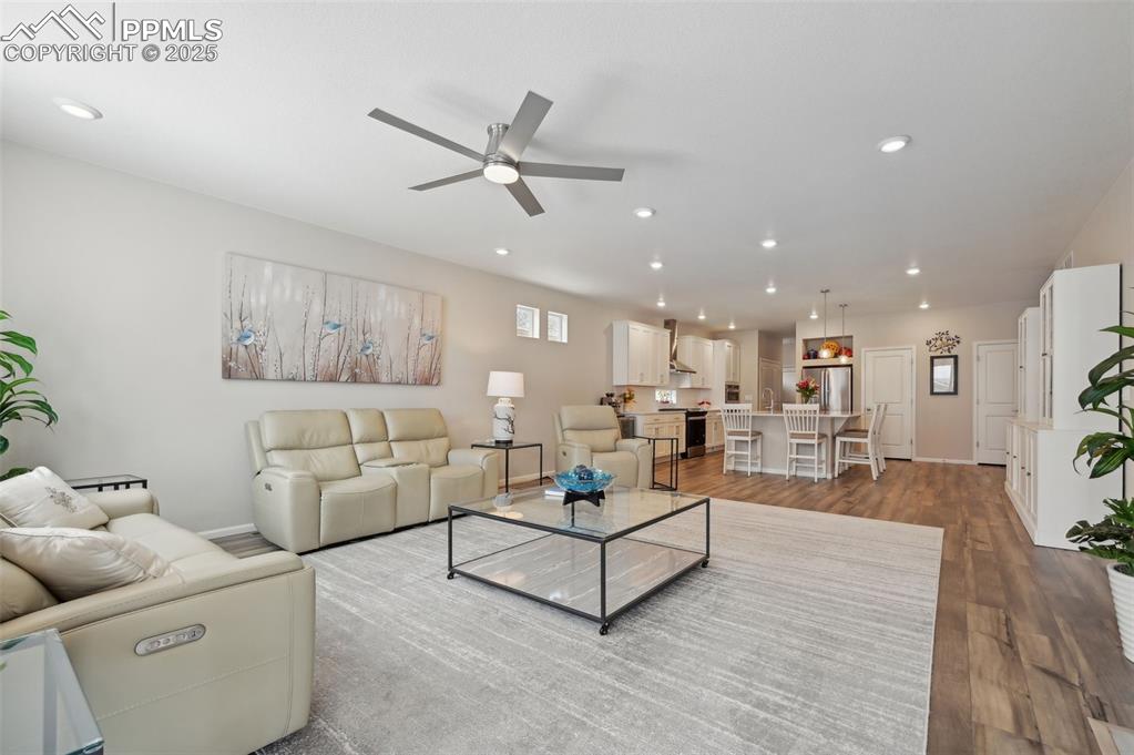 Image 12 of 44: Living area featuring ceiling fan, wood finished floors, recessed lighting,