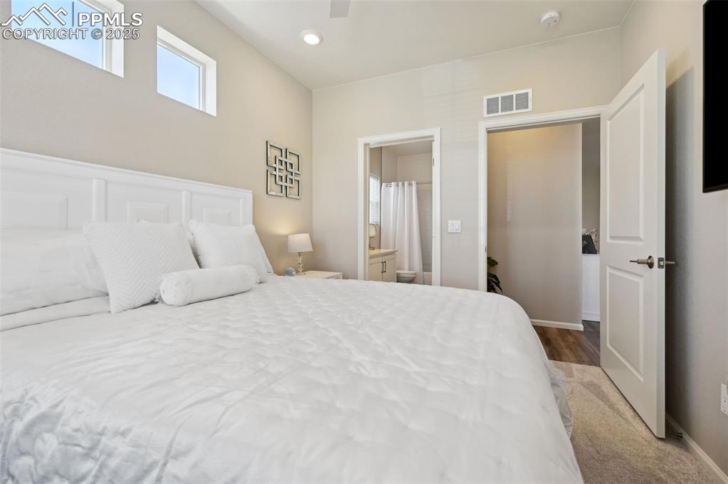 Image 21 of 44: Bedroom with ensuite bathroom, ceiling fan, baseboards, recessed lighting,