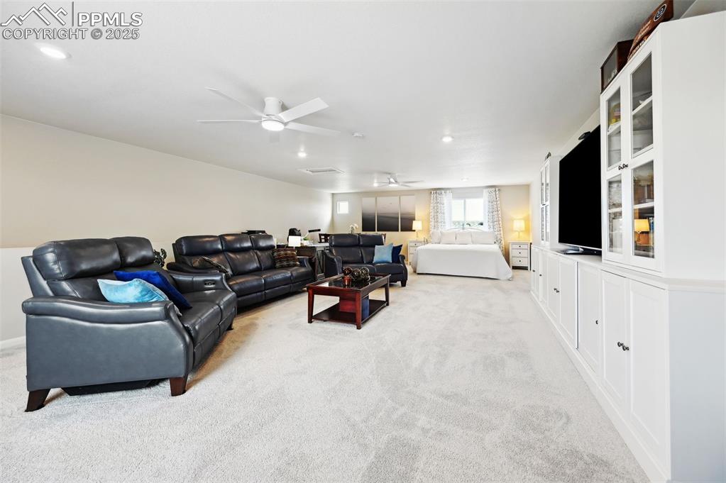 Image 25 of 44: Living area with ceiling fan, light carpet, and recessed lighting
